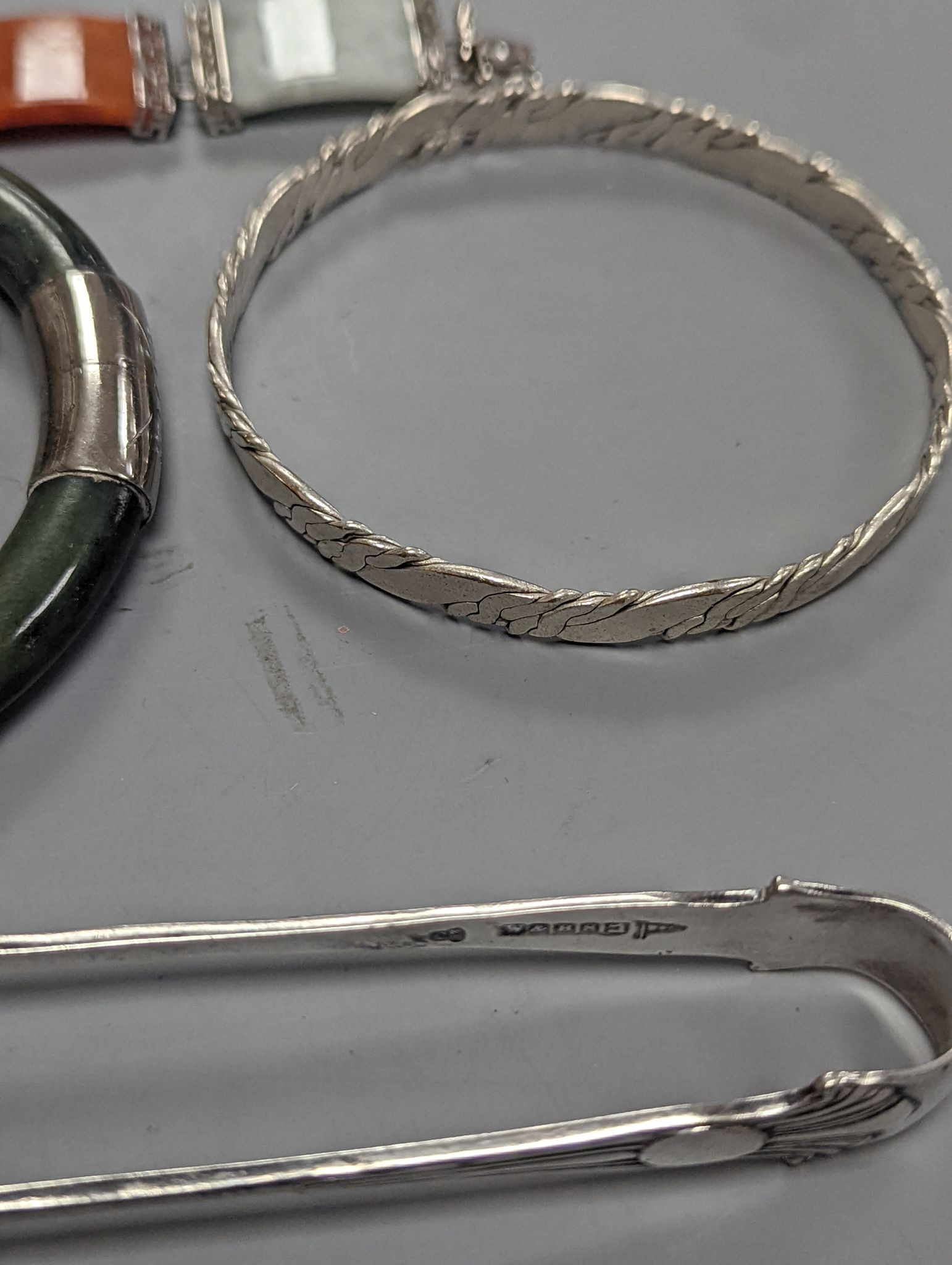 A 925 and hardstone set bracelet, 19.7cm, one other bracelet, two cameo shell brooches, three assorted bangles and a pair of sugar tongs.